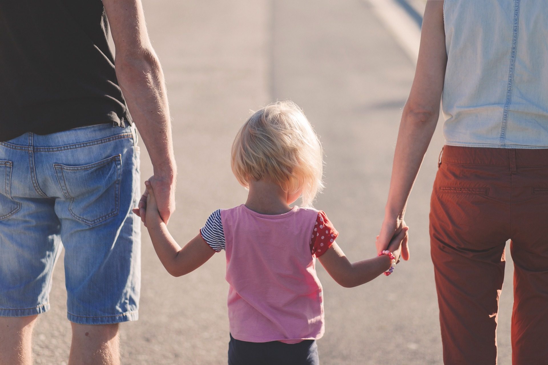 Girl walking with parents